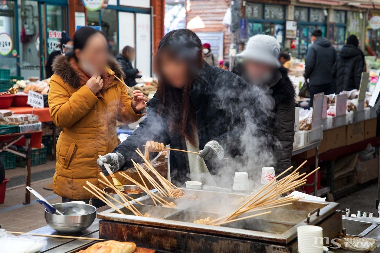 강한 바람으로 체감기온이 뚝 떨어진 2일 춘천 풍물시장, 시민들이 어묵을 먹으며 추위를 이겨내고 있다. (사진=이정욱 기자)